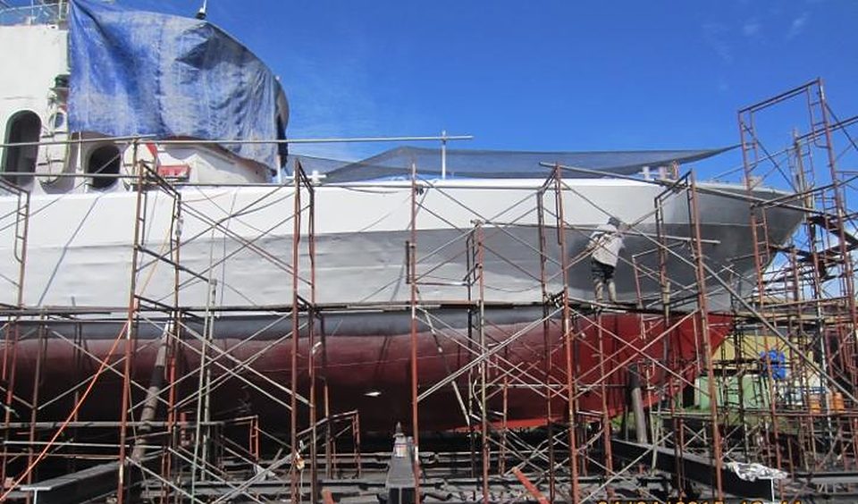 Vessel hull inside scaffolding during docking